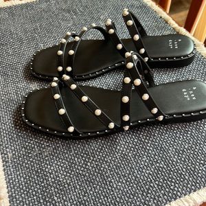 Black sandals with pearl accents